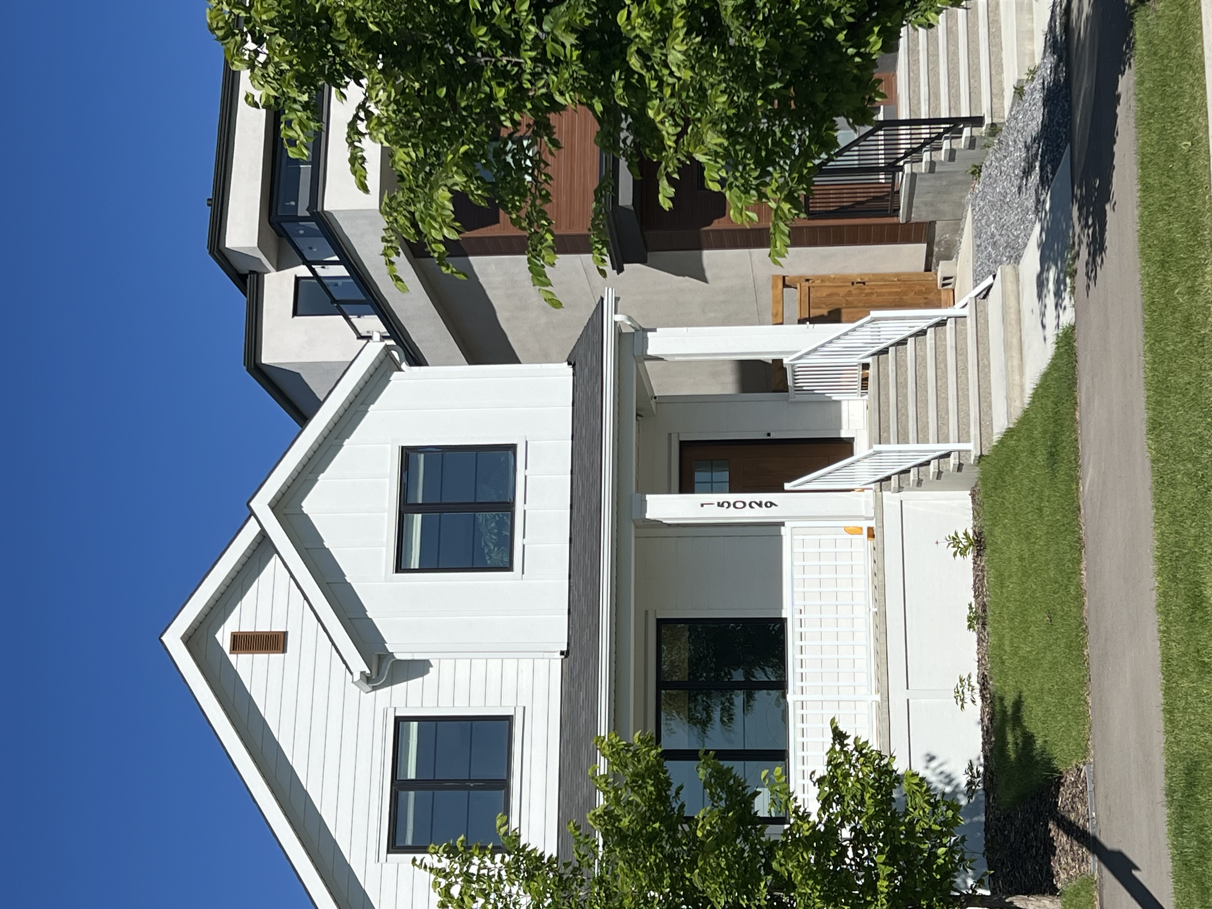 Completed Calgary exterior with light siding and dark trim